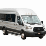 A silver Ford Transit passenger van.