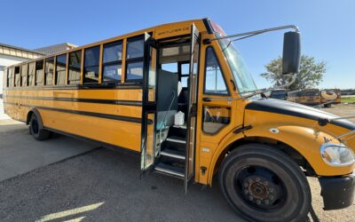 Yellow school bus parked with door open.