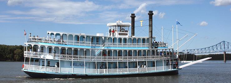 White riverboat named Twilight with people on board.