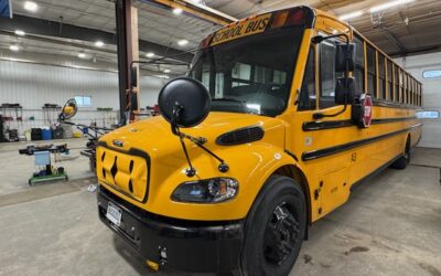 Yellow school bus parked in maintenance garage